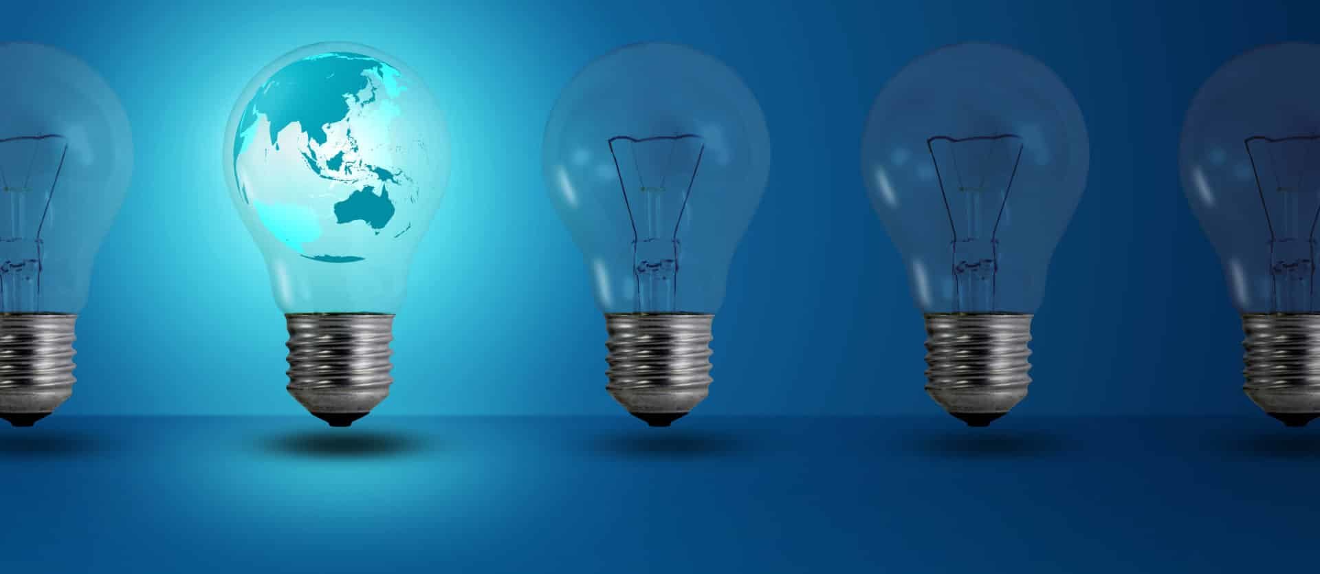 map inside glow among other light bulb on a blue background